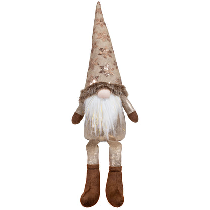 Wichtel als Kantenhocker mit einer Stoffmütze. Die Mütze ist mit Pailletten in Form von Schneeflocken besetzt. Im weißen Bart sind dezente Goldsträhnen eingearbeitet. Dadurch bekommt der Wichtel eine sehr edle und erhabene Optik. Höhe: ca. 55 cm (Gesamtlänge vom Fuß bis zum Ender der langgezogenen Mütze) - Material: Stoff, Samt, Pailletten, Fell - Farben: braun, bronze