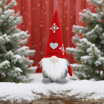 Wichtel - Santa sitzend mit Herz auf der Mütze, sowie gestickter Schneeflocke mit Strasssteinen. Der Wichtel besteht aus einem strapazierfähigen Filz mit einer Holznase . Höhe: ca. 23 cm - 
Gewicht: ca. 200 g - Applikationen: Gestickte Schneeflocke mit Strasssteinen - Material: Filz, Holz, Strasssteine - Farben: rot, weiß, grau